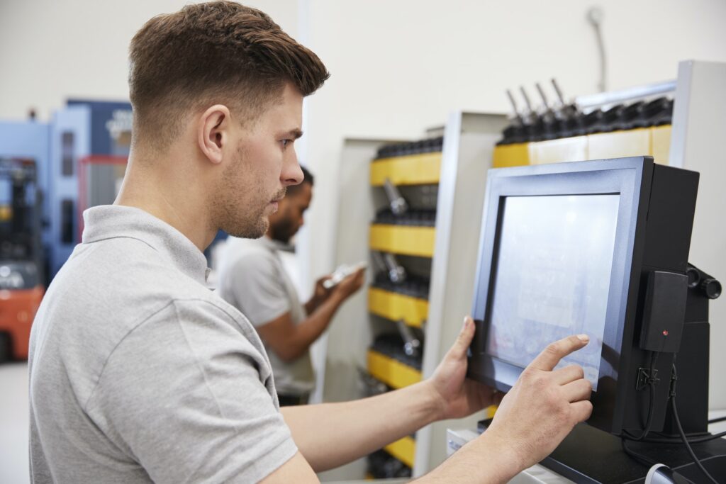 Engineers Selecting Tools For Use On Machinery In Factory